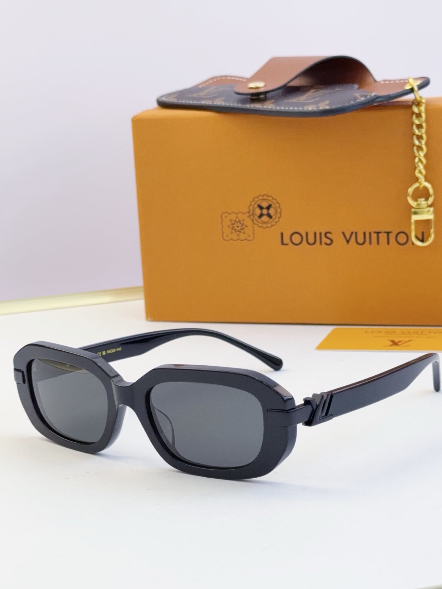 Louis Vuitton glasses, dark blue frames with gray tinted lenses and gold hinges