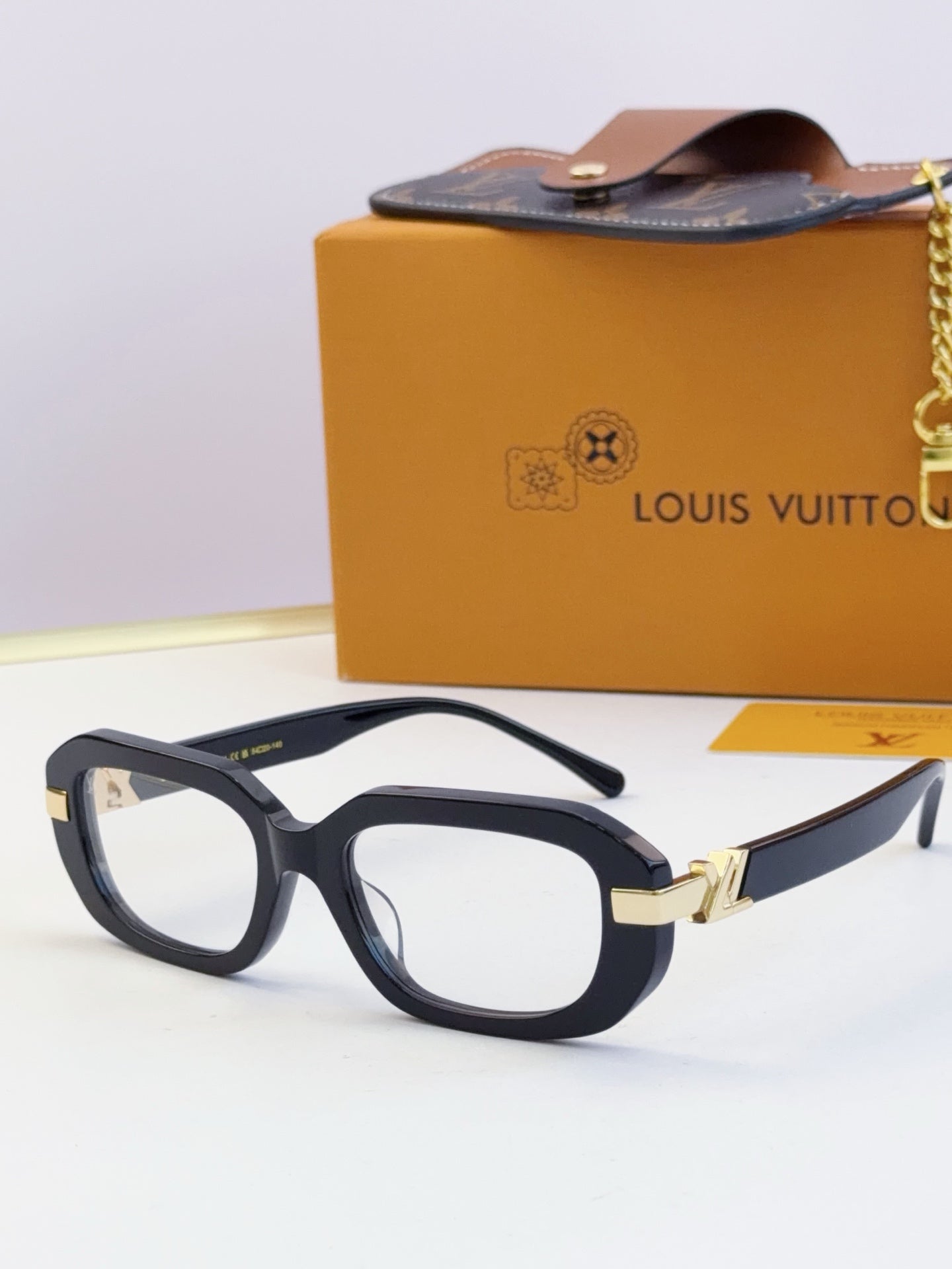 Louis Vuitton glasses, dark frames with gold bridge and gray lenses