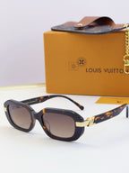 Louis Vuitton glasses, dark frames with patterned arms and brown tinted lenses