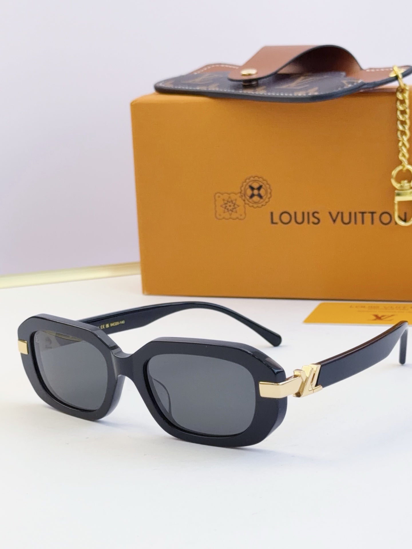 Louis Vuitton glasses, dark blue frames with gray lenses and gold-tone details
