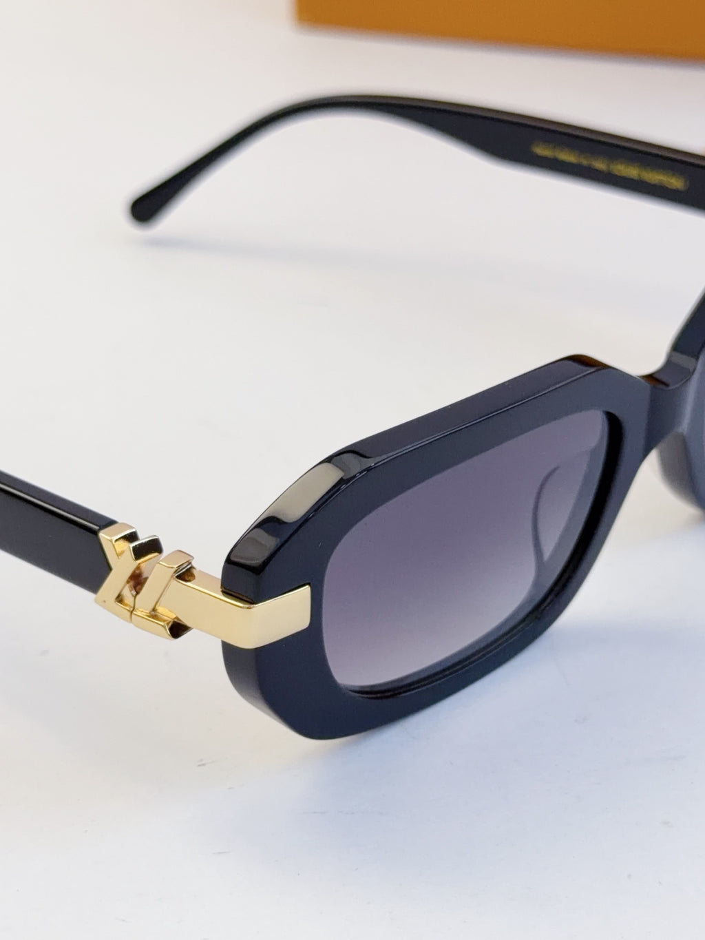 Louis Vuitton glasses with dark navy frames, curved temples, and tinted lenses