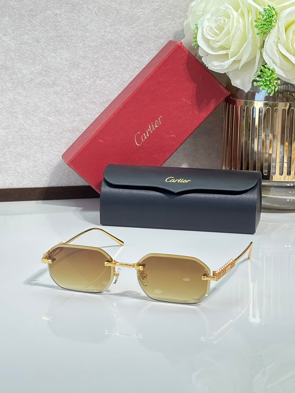 Cartier sunglasses with gold-tone metal frame and yellow tinted lenses
