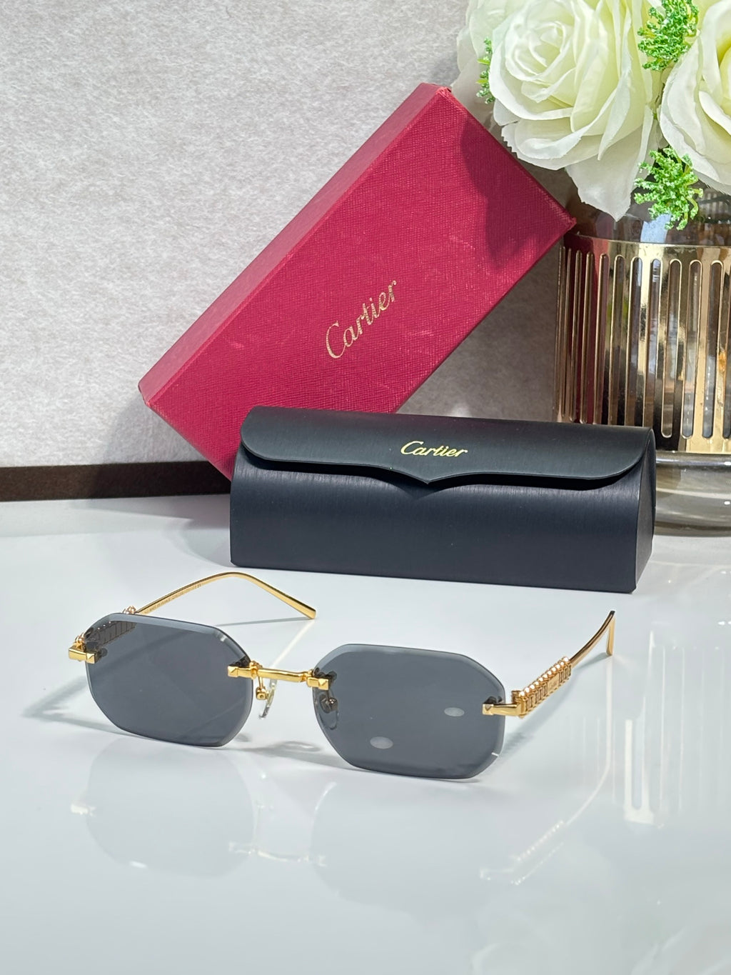 Cartier sunglasses with gold-tone metal frame and dark gray tinted lenses