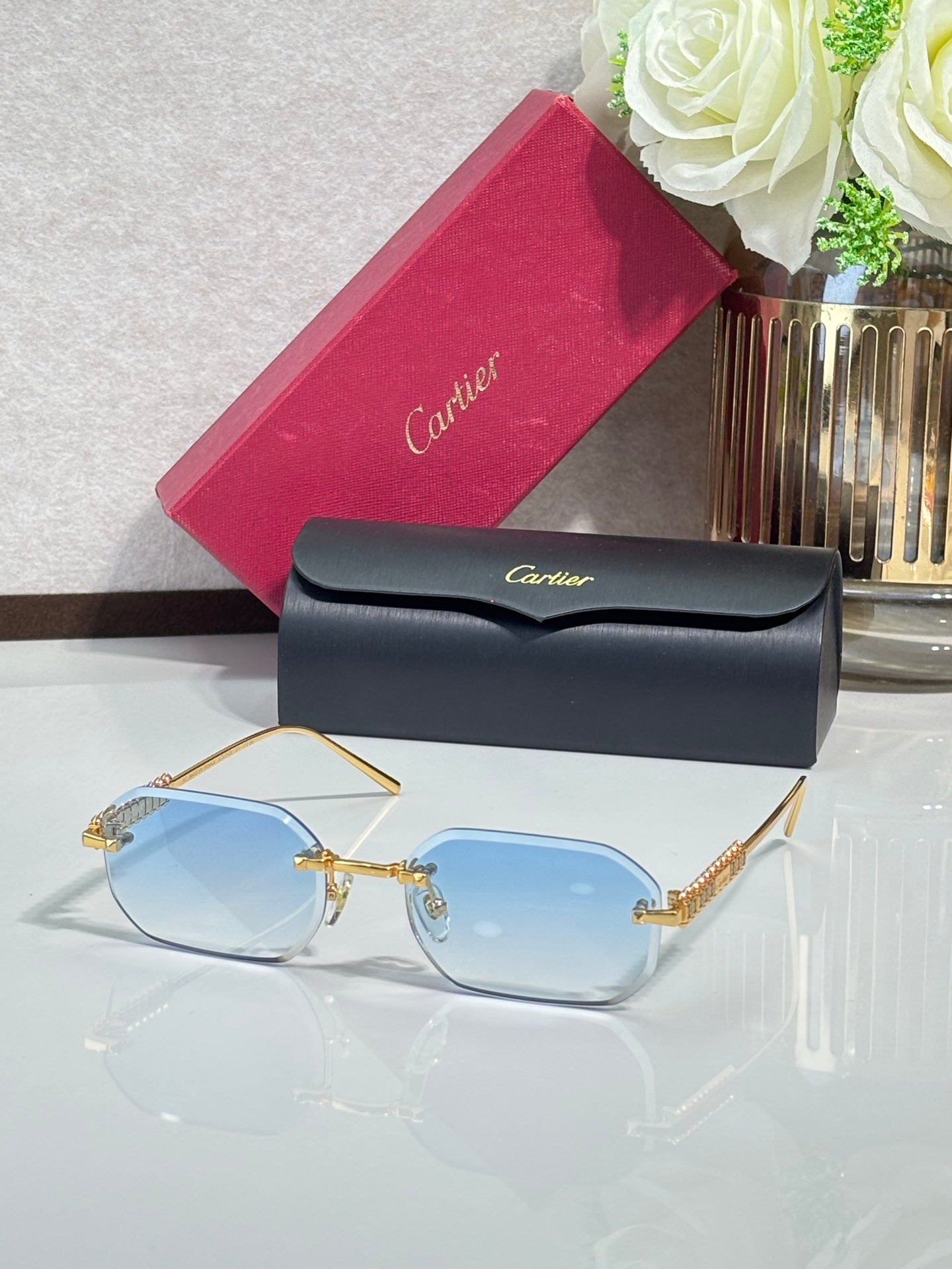 Cartier sunglasses with gold-tone metal frame and light blue tinted lenses