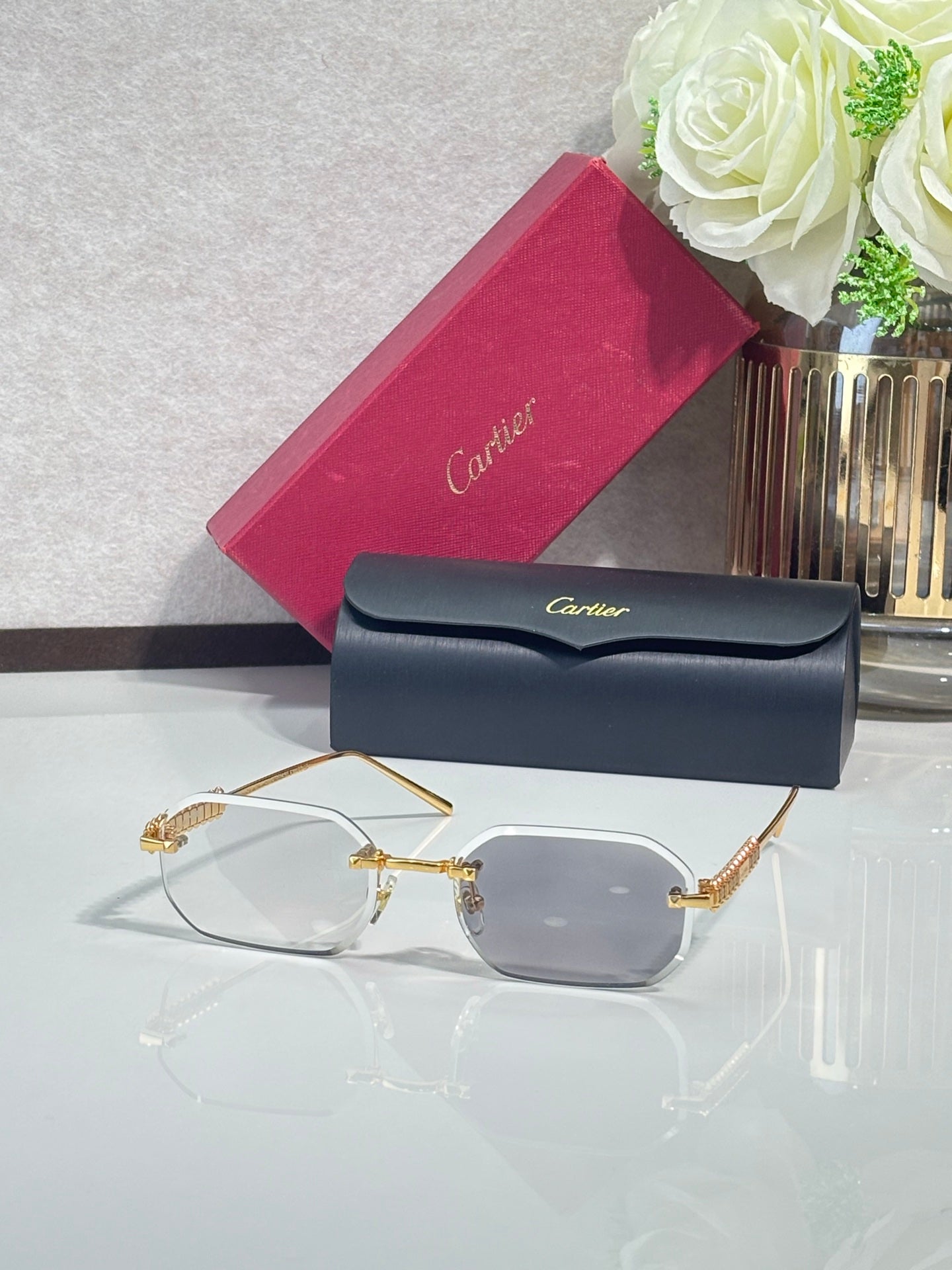Cartier sunglasses with gold-tone metal frame and clear tinted lenses