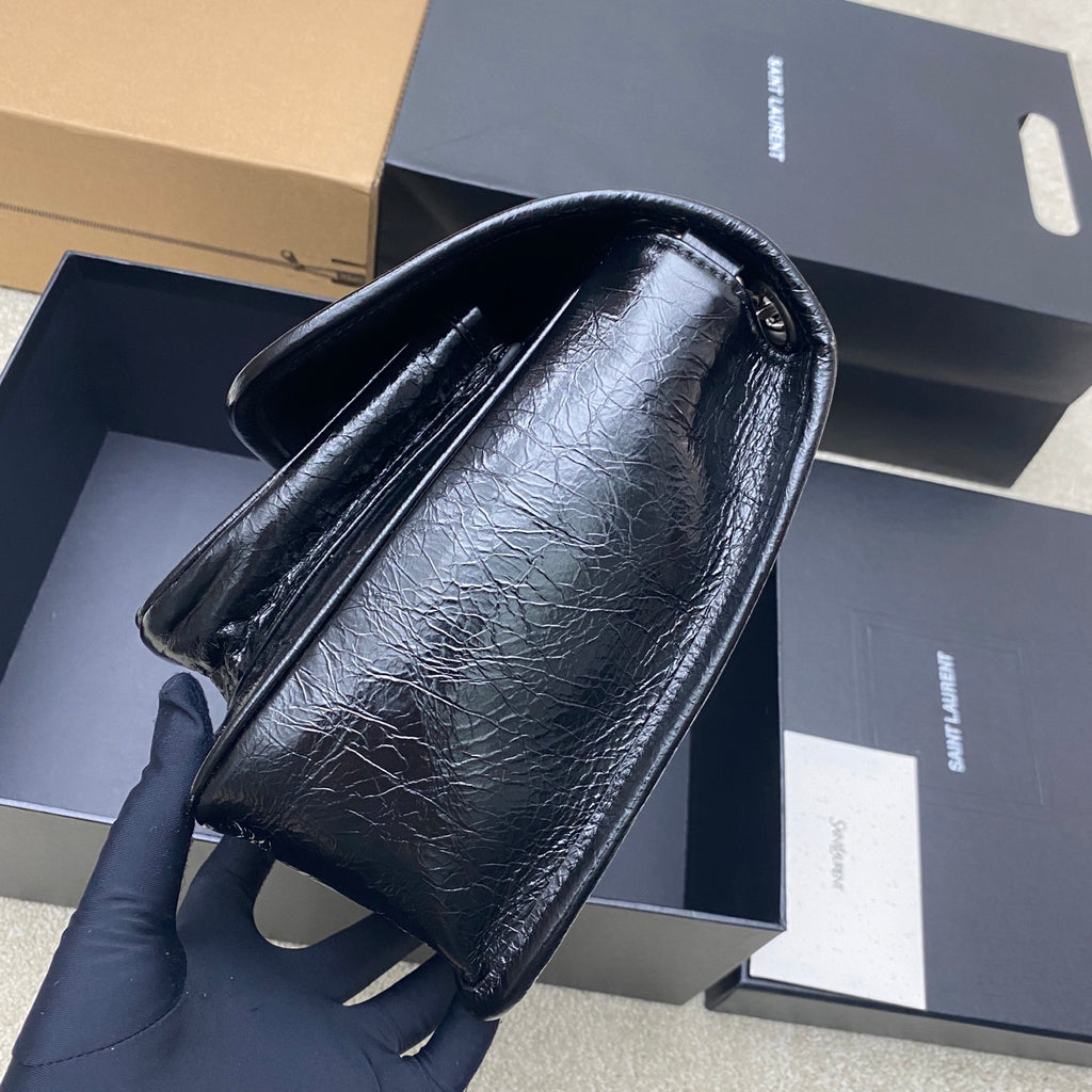 Saint Laurent leather shoulder bag, side view with chain strap and curved flap