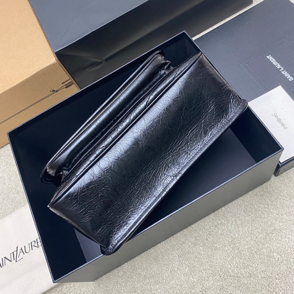Saint Laurent leather shoulder bag, top view showing long front flap and stitching