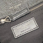 Saint Laurent leather bag close-up: zipper, brand print, and Made in Italy tag