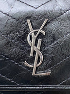 YSL metal logo on Saint Laurent quilted leather bag front