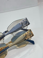 Close-up of sunglasses hinge with gold and silver details on blue temples