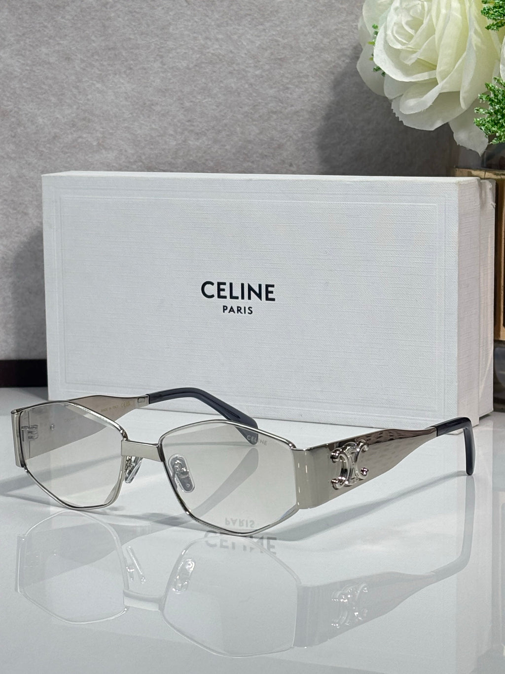Silver sunglasses with clear lenses and dark temple tips