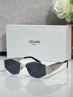 Gold and gray sunglasses with dark lenses and curved metal side embellishments