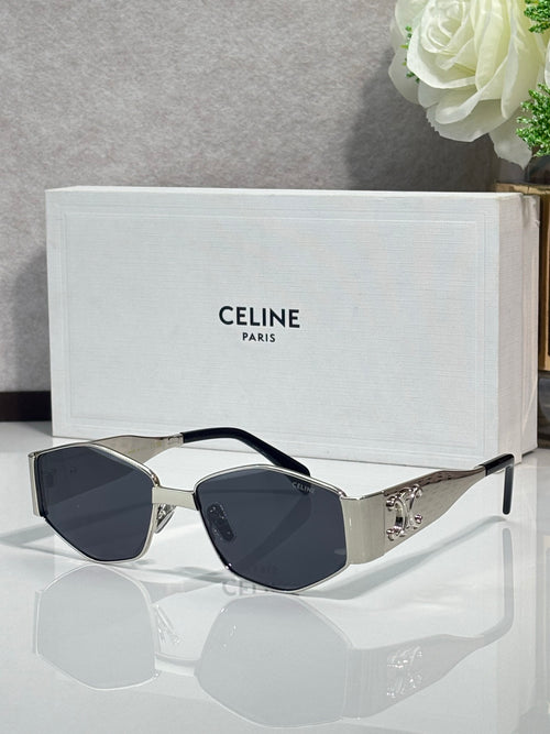 Gold and gray sunglasses with dark lenses and curved metal side embellishments