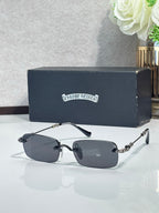 Rectangular eyeglasses with dark frames, blue lenses, and gold chain-style temple detail.