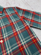 Teal plaid shirt with spread collar, red and yellow lines, and button closure