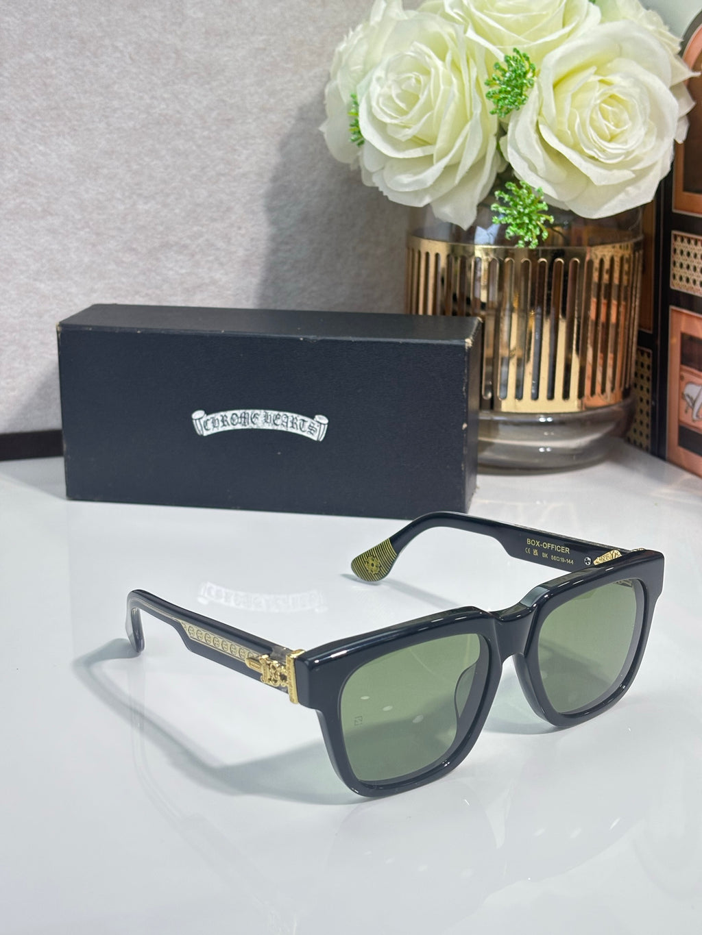 Blue-tinted rectangular sunglasses with green lenses, gold logo detailing