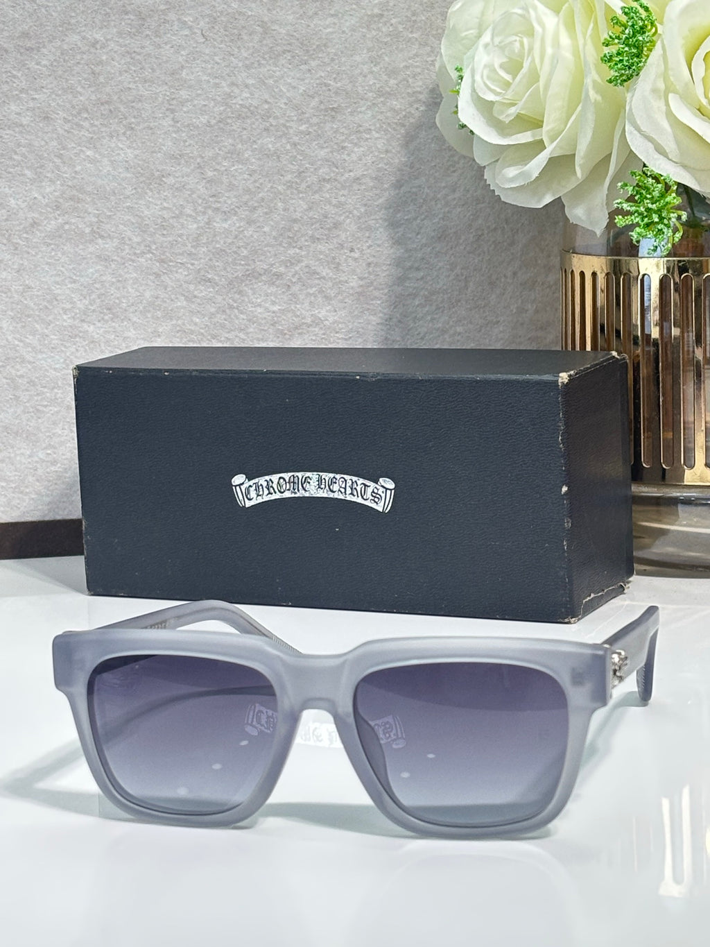 White rectangular sunglasses with light-purple tinted lenses and chrome metal temples
