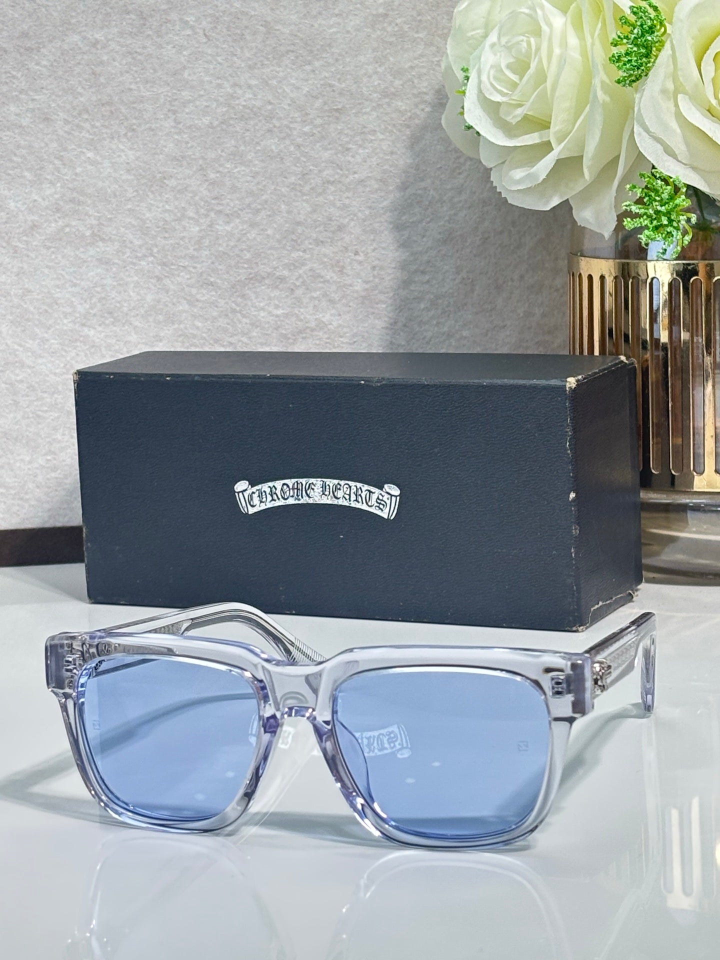 Light-clear rectangular sunglasses with blue-tinted lenses and chrome metal temples