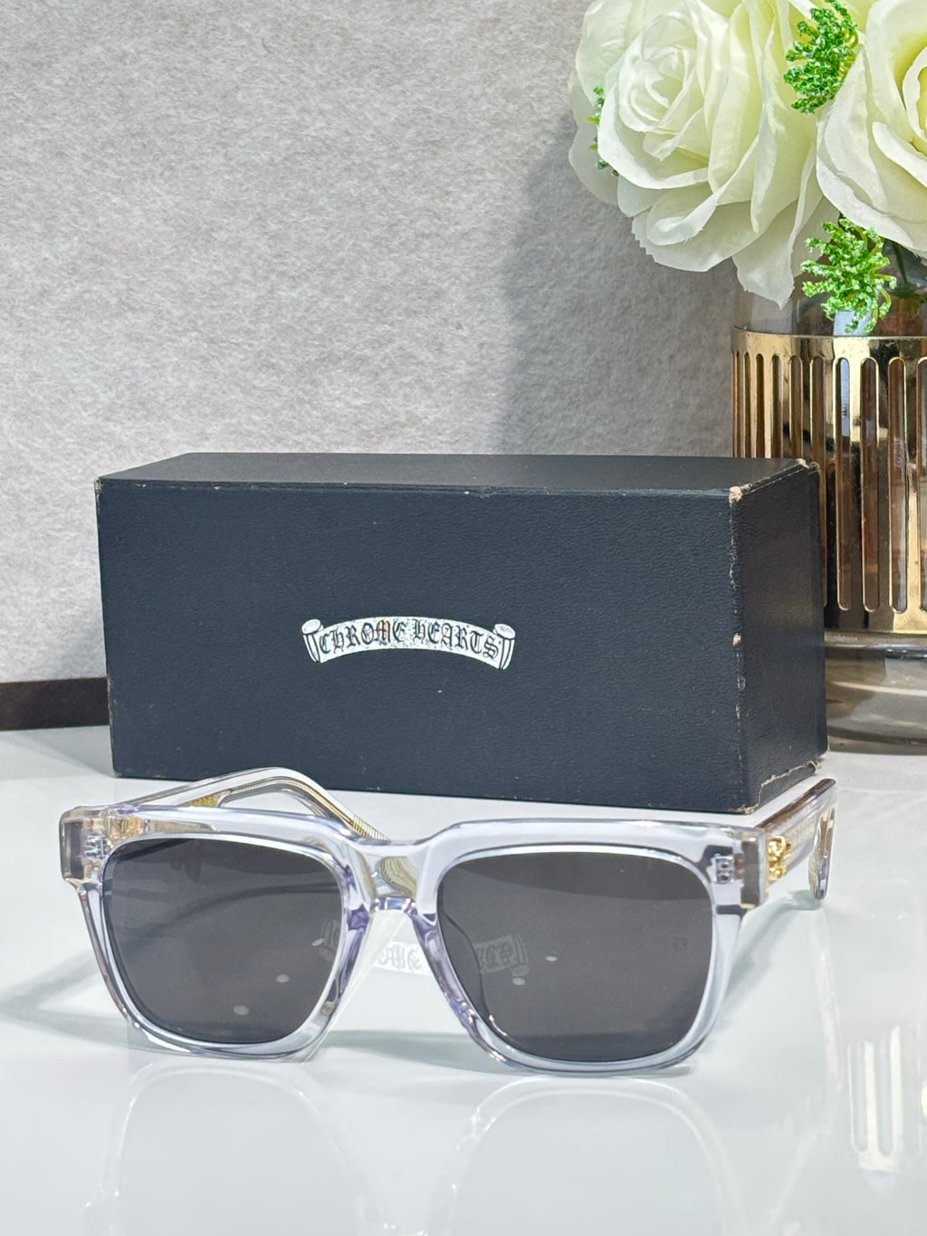 Clear rectangular sunglasses with dark lenses and chrome metal temples