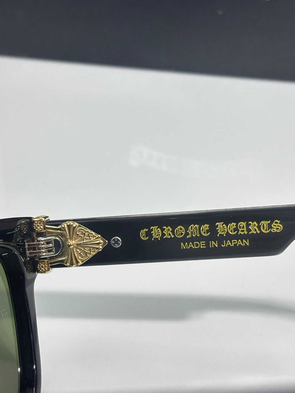 Sunglasses temple with gold text and 'MADE IN JAPAN' marking