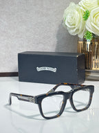 Chrome glasses with dark tortoiseshell rectangular frames and gold detailing