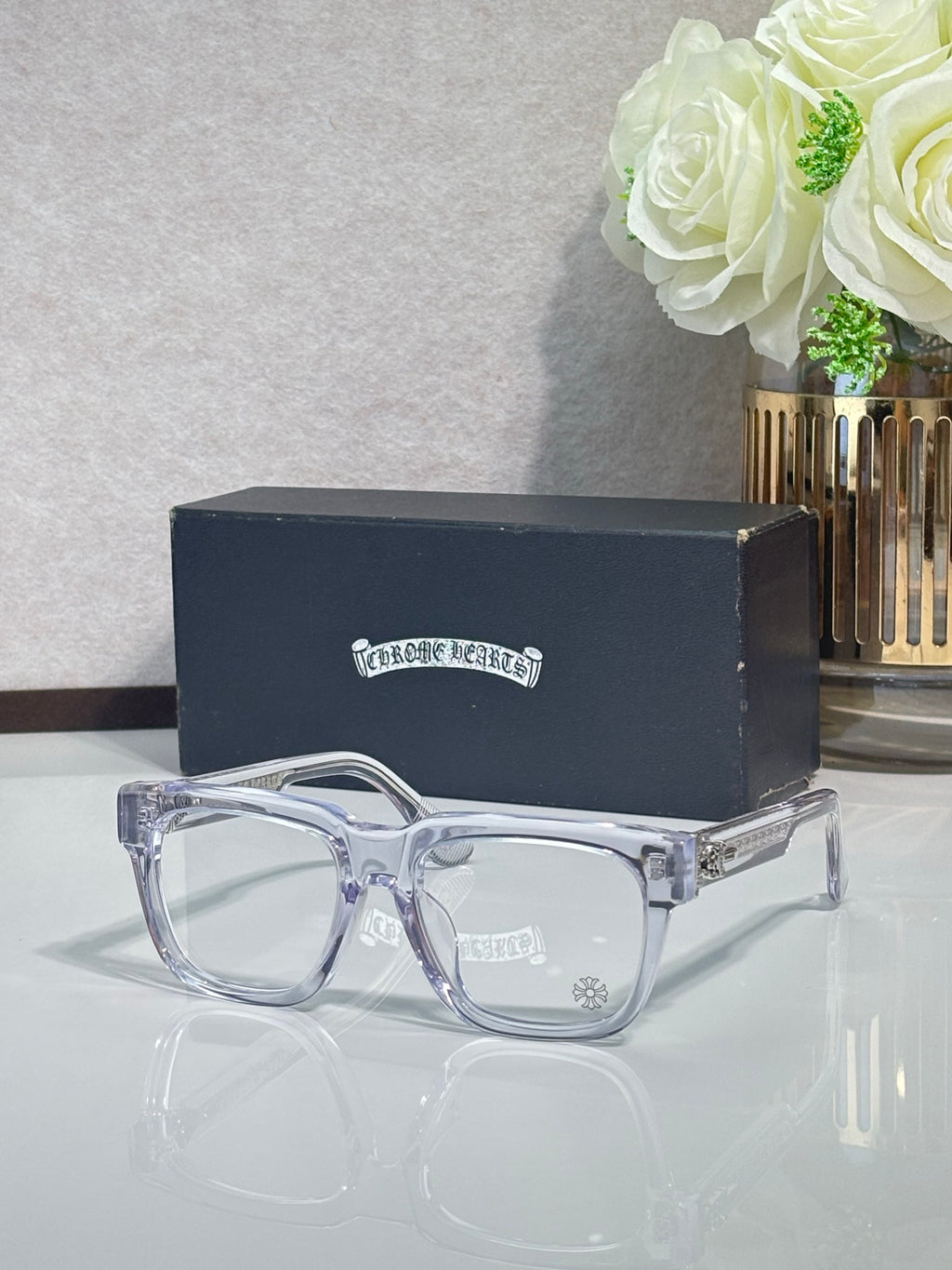 Chrome glasses with transparent rectangular frames and clear lenses