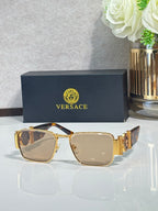 Gold-tone square eyeglasses with light beige lenses and decorative temple details