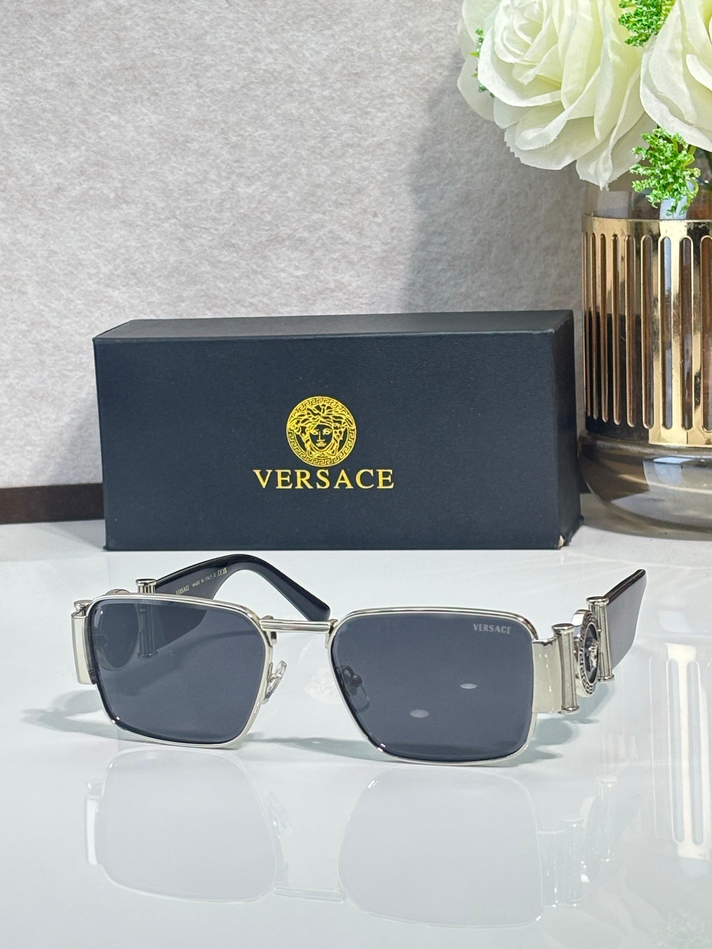 Gold-tone square eyeglasses with dark blue lenses and slim metal temple arms