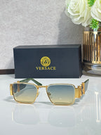 Gold-tone square eyeglasses with greenish-blue gradient lenses and engraved temples