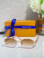 Round sunglasses with tinted lenses and rose-gold frame with gold hardware