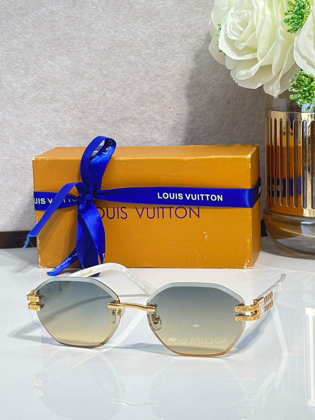 Round sunglasses with light lenses and gold-tone frame details