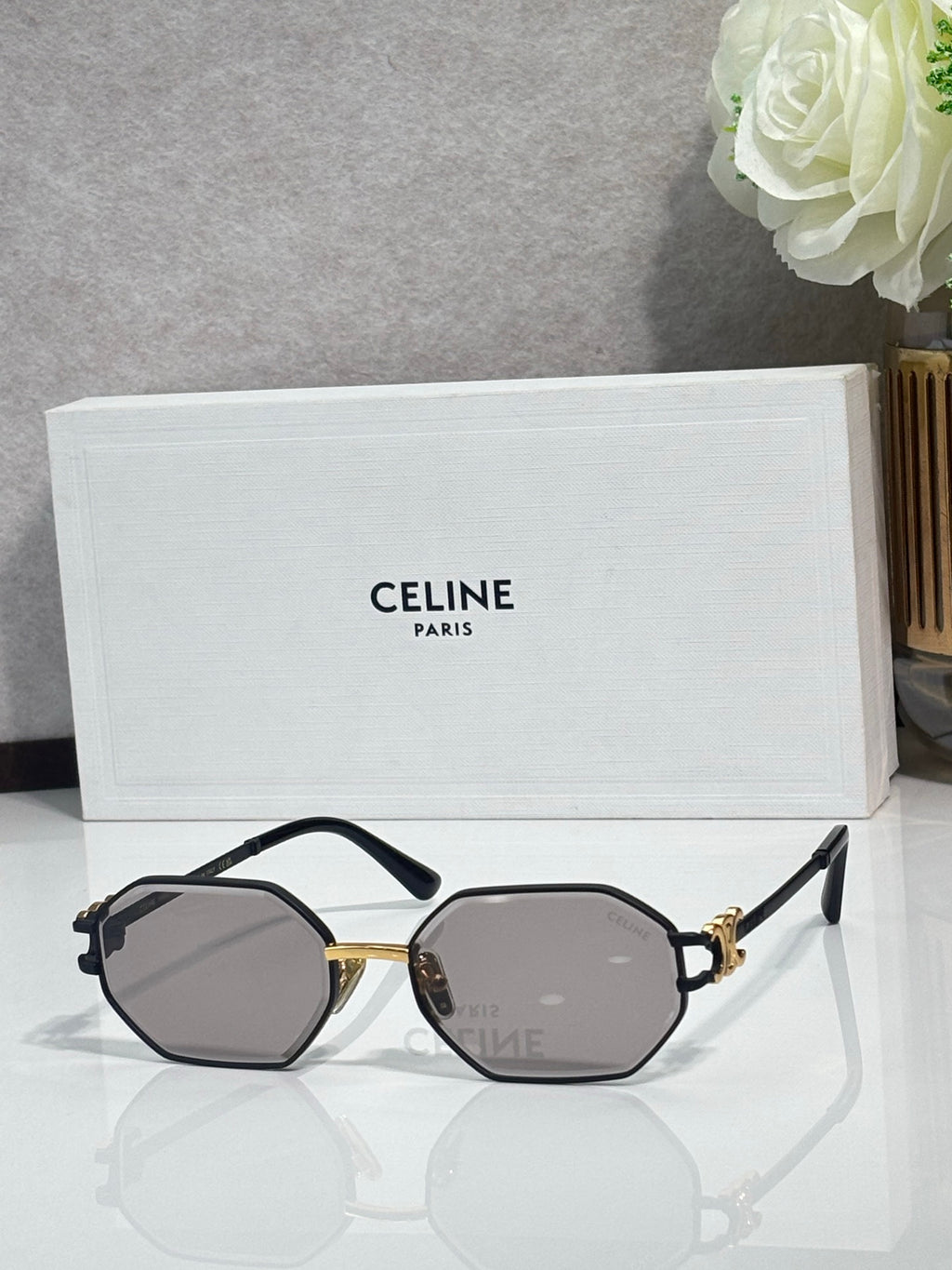 Celine octagonal sunglasses with dark frame, gold accents, and gray lenses, front view