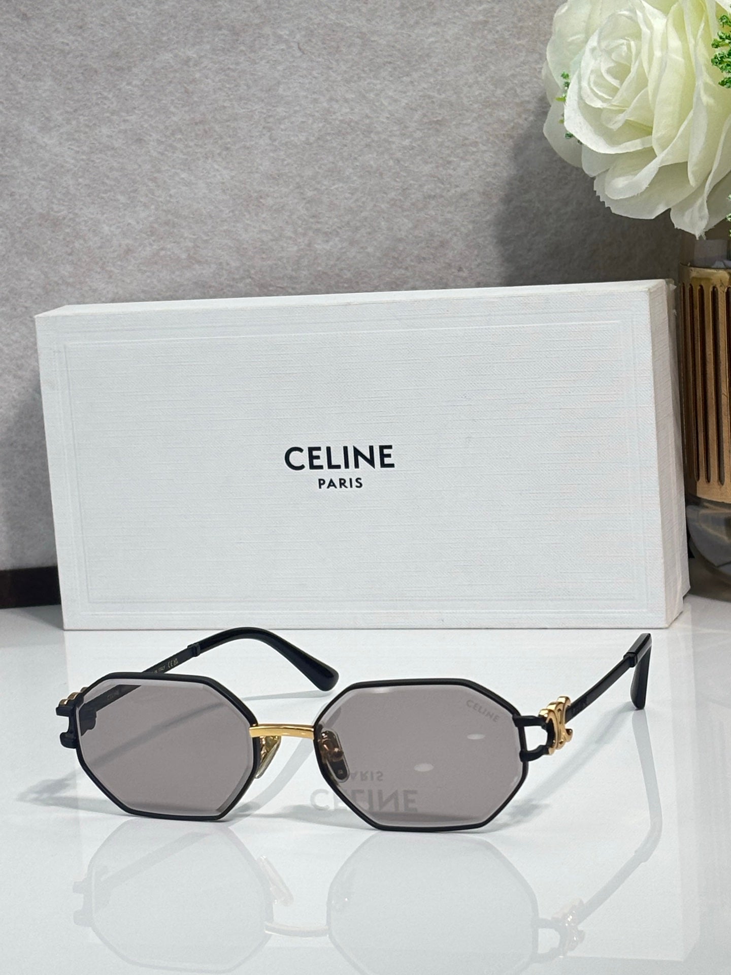 Celine octagonal sunglasses with dark frame, gold accents, and gray lenses, front view