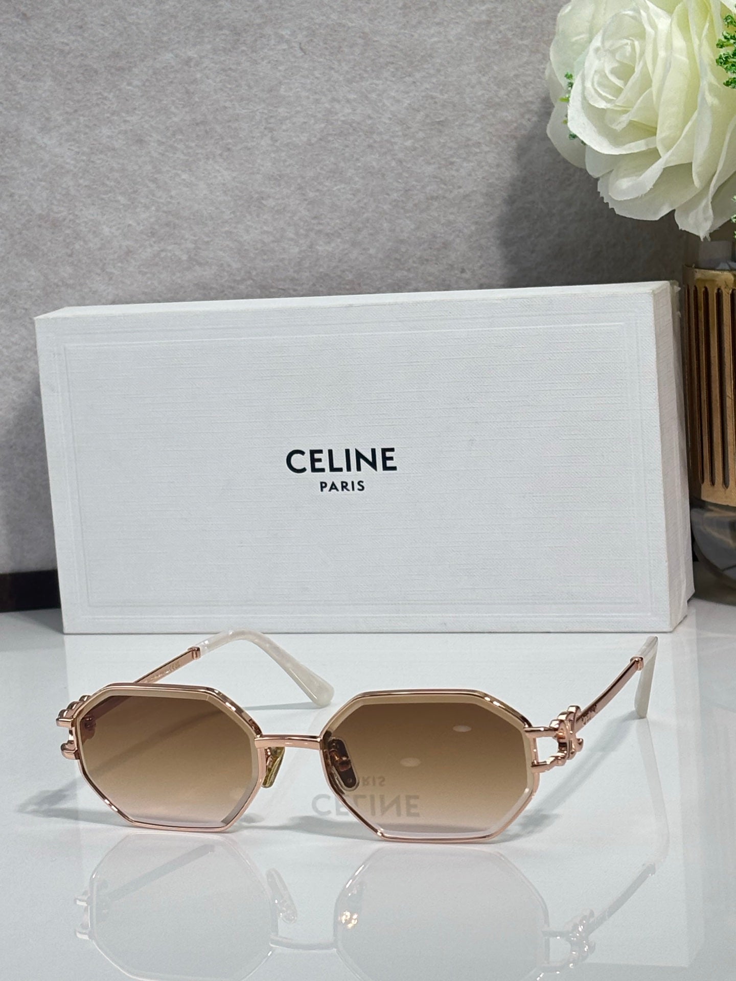 Celine octagonal sunglasses with gold-tone frame and light brown lenses, side view