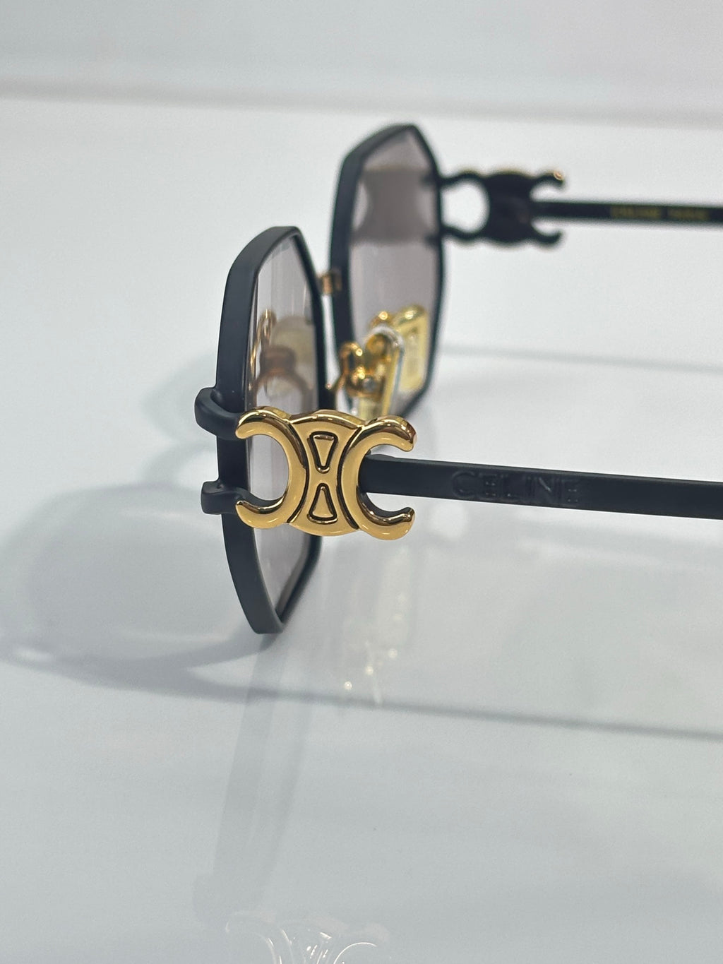 Celine sunglasses with dark frame and gold-tone hinges, side profile