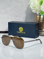 Sunglasses with dark brown lenses and silver-tone frames, gold logo detail on temple