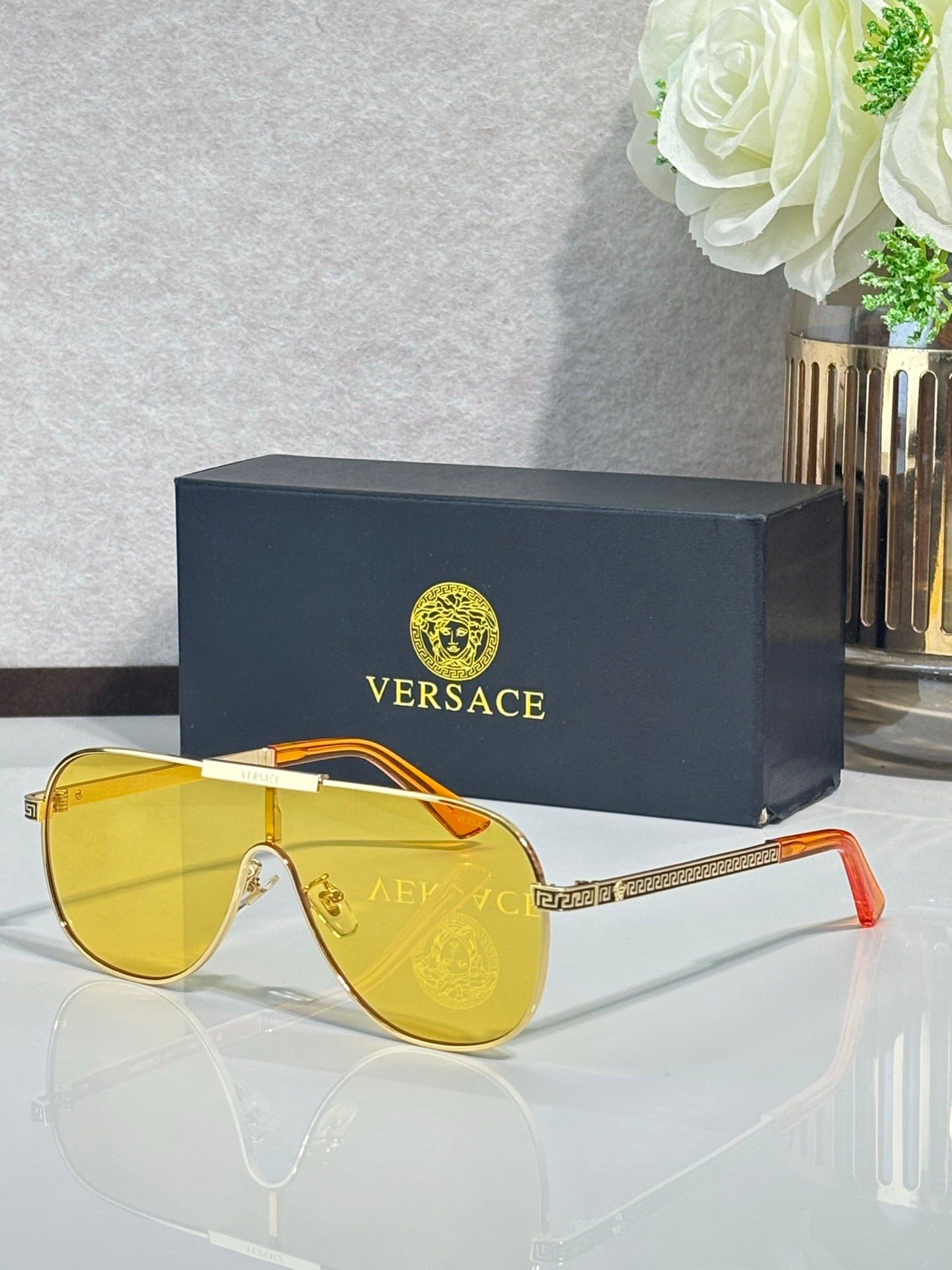 Sunglasses with gold and orange frames and yellow gradient lenses