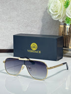 Sunglasses with dark blue frames and gradient gray-blue lenses, gold logo detail on temple