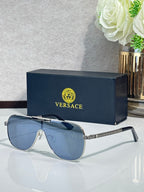 Sunglasses with dark blue frames and gradient blue lenses, ornate metal temple detail