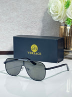 Sunglasses with dark frames and gradient gray lenses, metal temple detail near the hinge