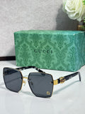 Gucci sunglasses with black square frames, dark gray lenses, and gold logo accents