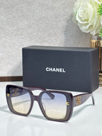 Chanel sunglasses with dark burgundy wide frames and gold CC logos