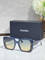 Chanel sunglasses with blue oversized frames and gold CC logos
