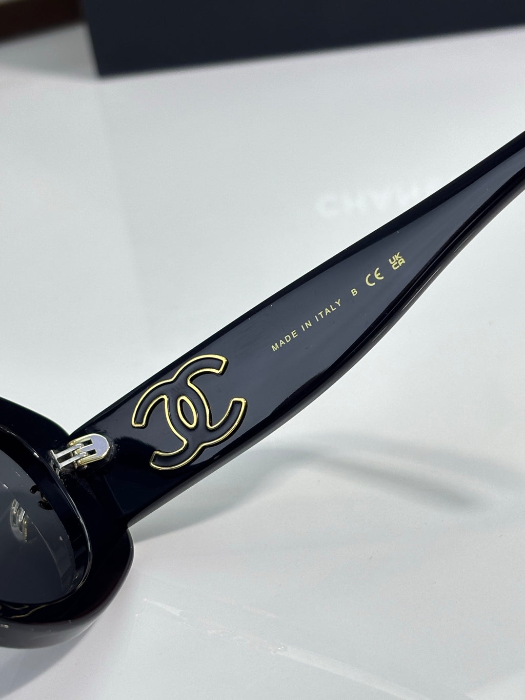 Chanel cat-eye sunglasses with gold script on dark blue temple and metal hinge