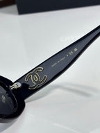 Chanel cat-eye sunglasses with gold script on dark blue temple and metal hinge