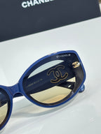 Chanel cat-eye sunglasses in dark blue with gold logo on side arms