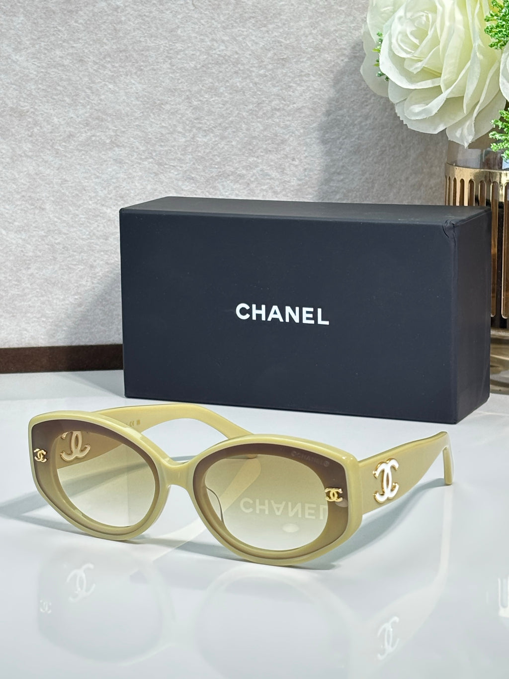 Chanel cat-eye sunglasses in bright blue with gold logo on dark lenses