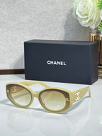 Chanel cat-eye sunglasses in bright blue with gold logo on dark lenses