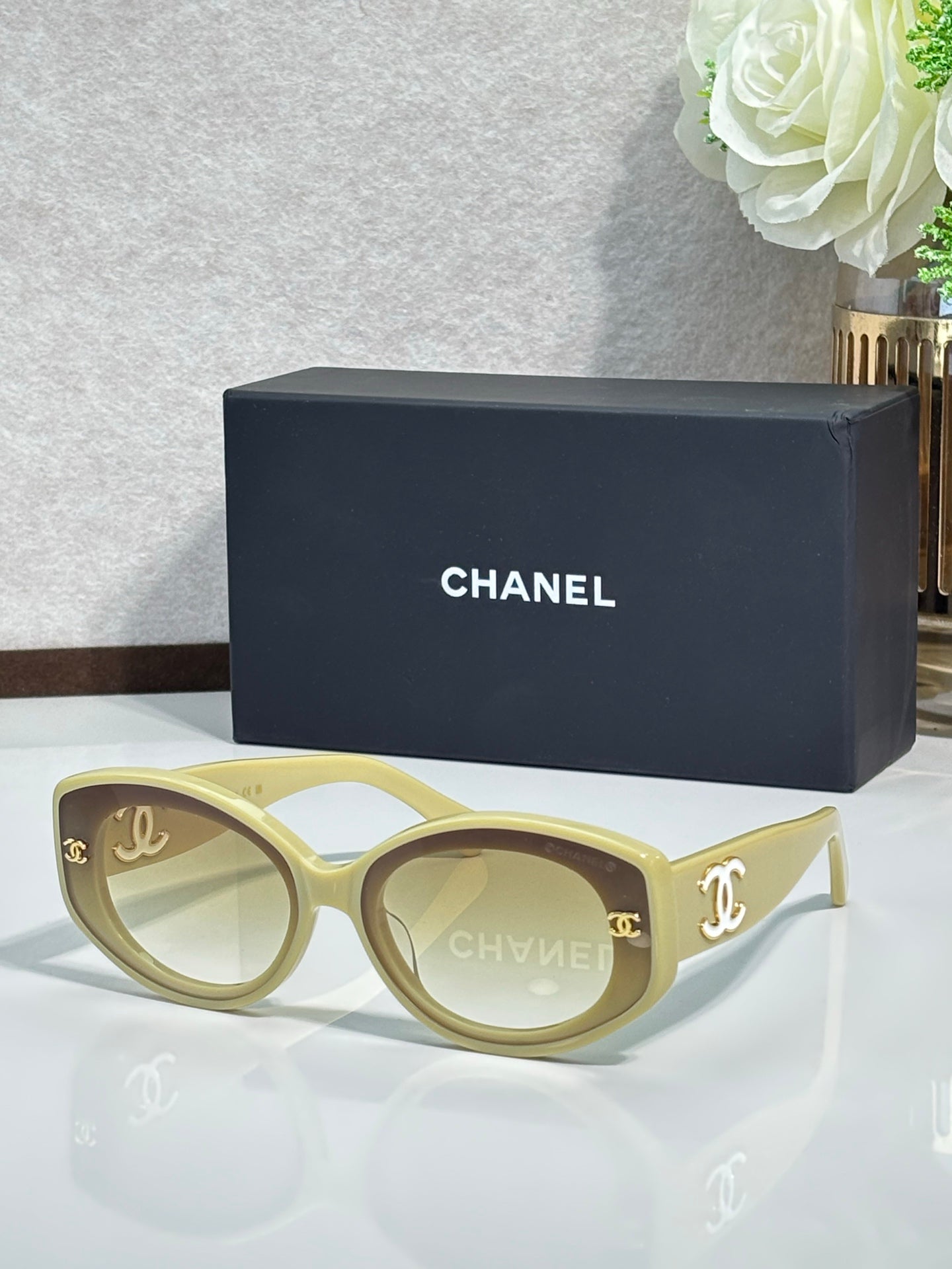 Chanel cat-eye sunglasses in bright blue with gold logo on dark lenses