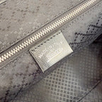 Gucci tote bag interior label patch on patterned lining near zipper